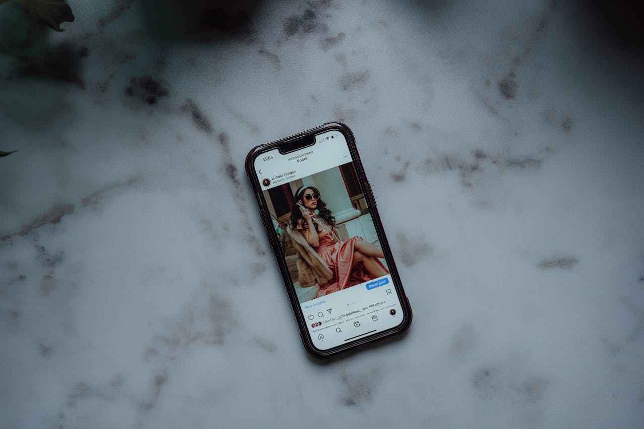 A smartphone showing an Instagram post against a marble background, showcasing modern social media use.